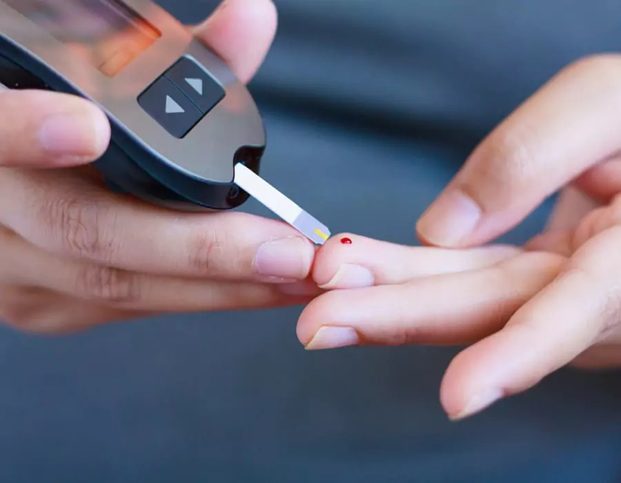 Patient testing his own blood glucose